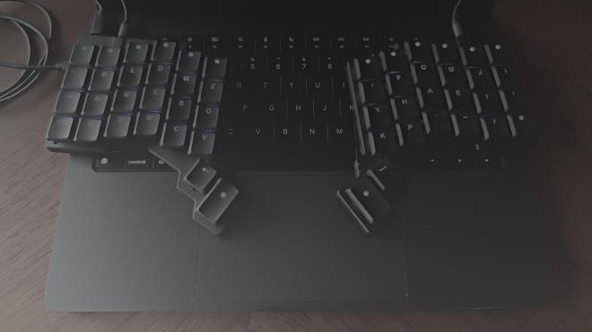 Image of a ZSA Voyager split keyboard with a Graphite Layout